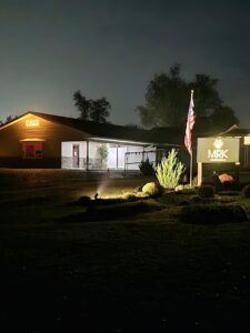 Marsh Run Kennels at night with illuminated building and sign in Waynesboro PA dog boarding facility